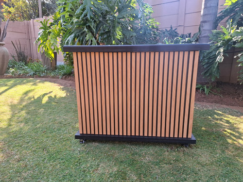 Wooden mobile bar table on grass in garden setting