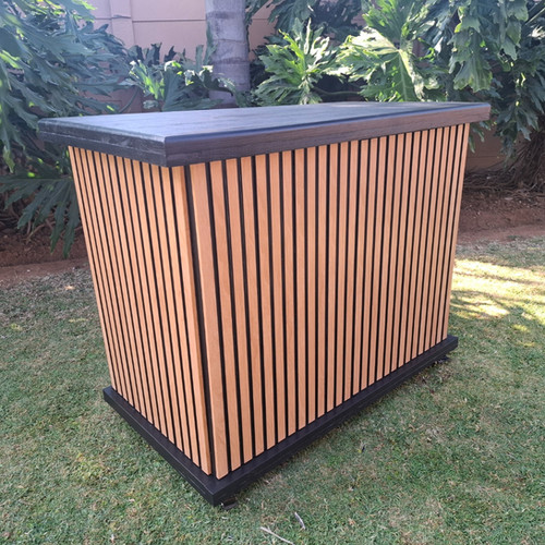 Mobile bar table with wooden slat design on lawn.