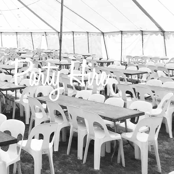 Large marquee interior with rows of tables and chairs