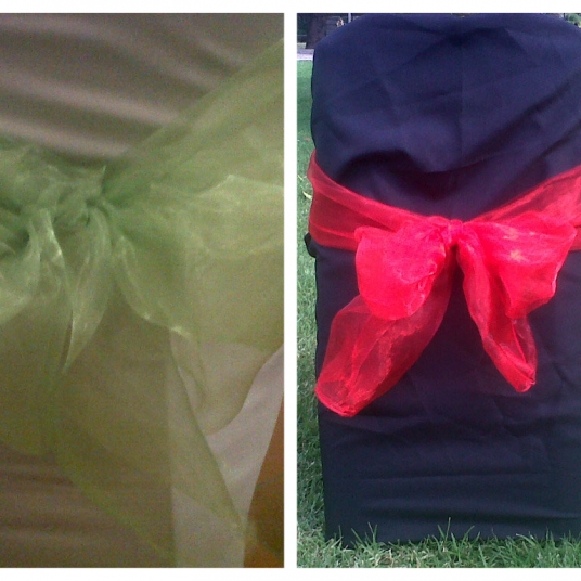 Black chair covers with green and red sashes
