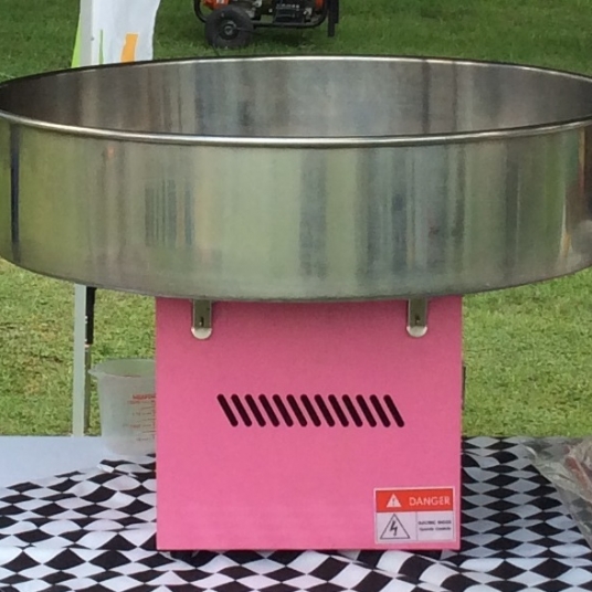 Cotton candy machine with pink base and metal bowl