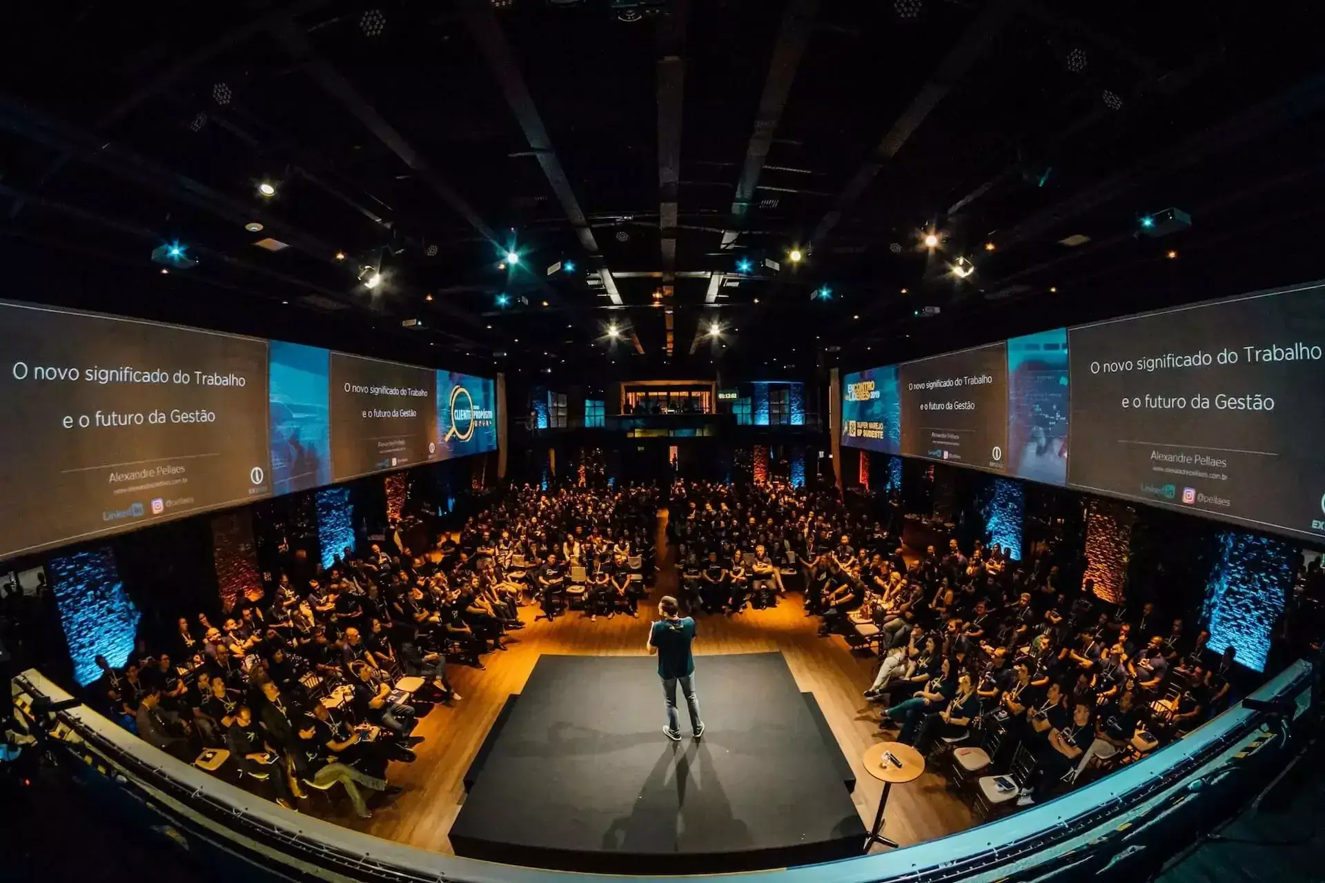 Wide view of a corporate event setup with audience and stage