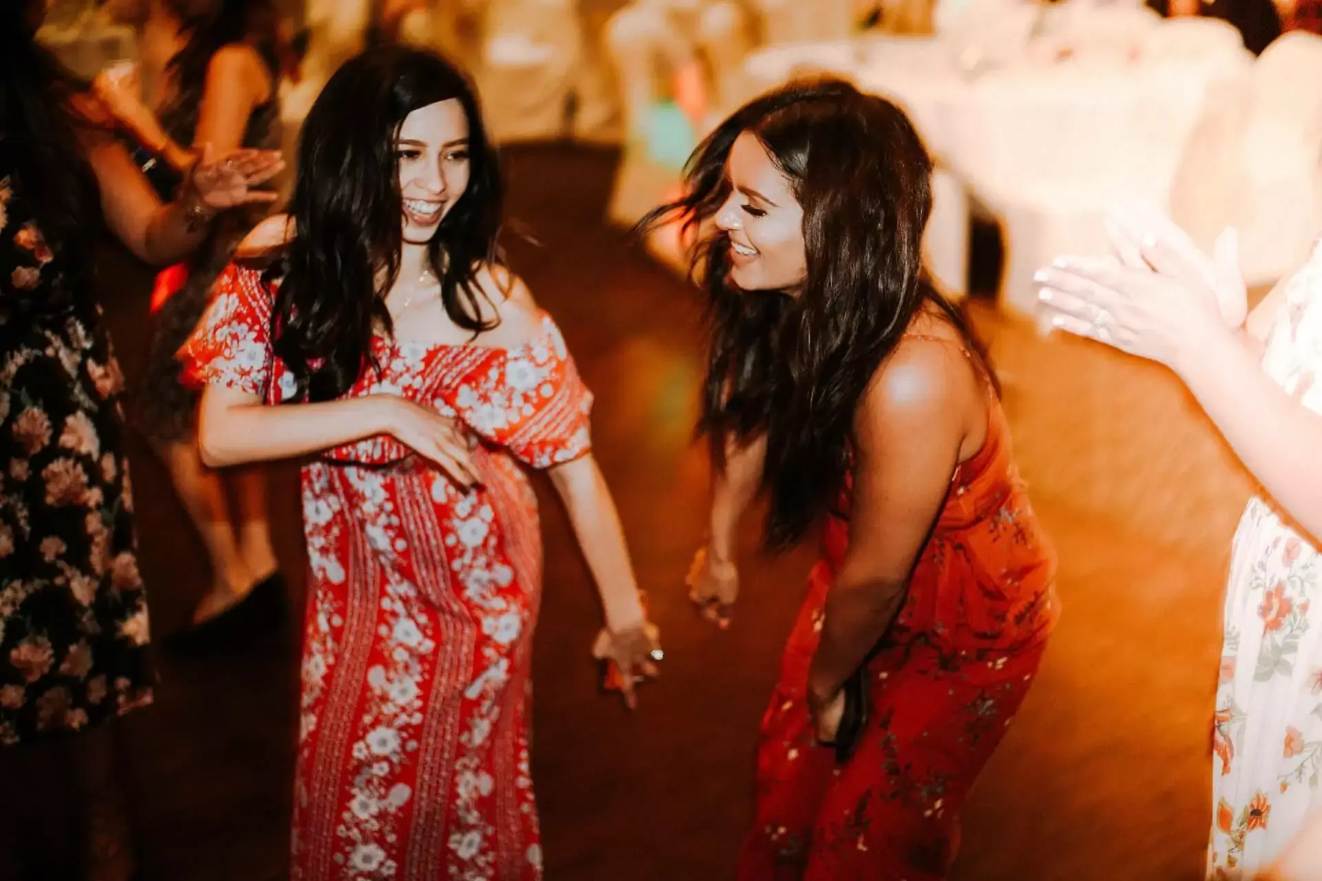 Two women dancing joyfully at a party.