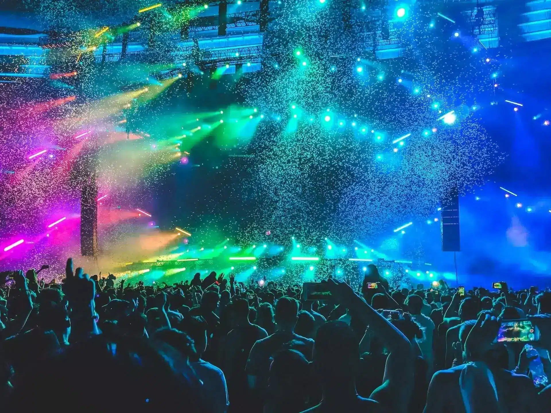 Colorful event lighting with confetti and crowd