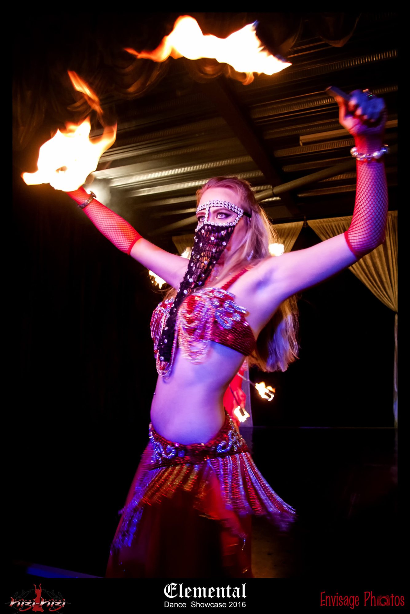 Belly dancer performing with fire props