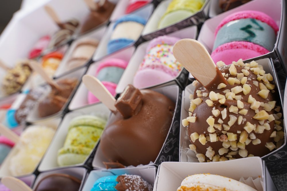 A colorful assortment of macarons and chocolate treats on display.