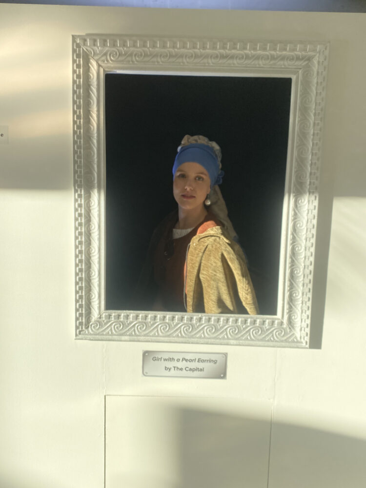 Artwork titled 'Girl with a Pearl Earring' displayed at an event.