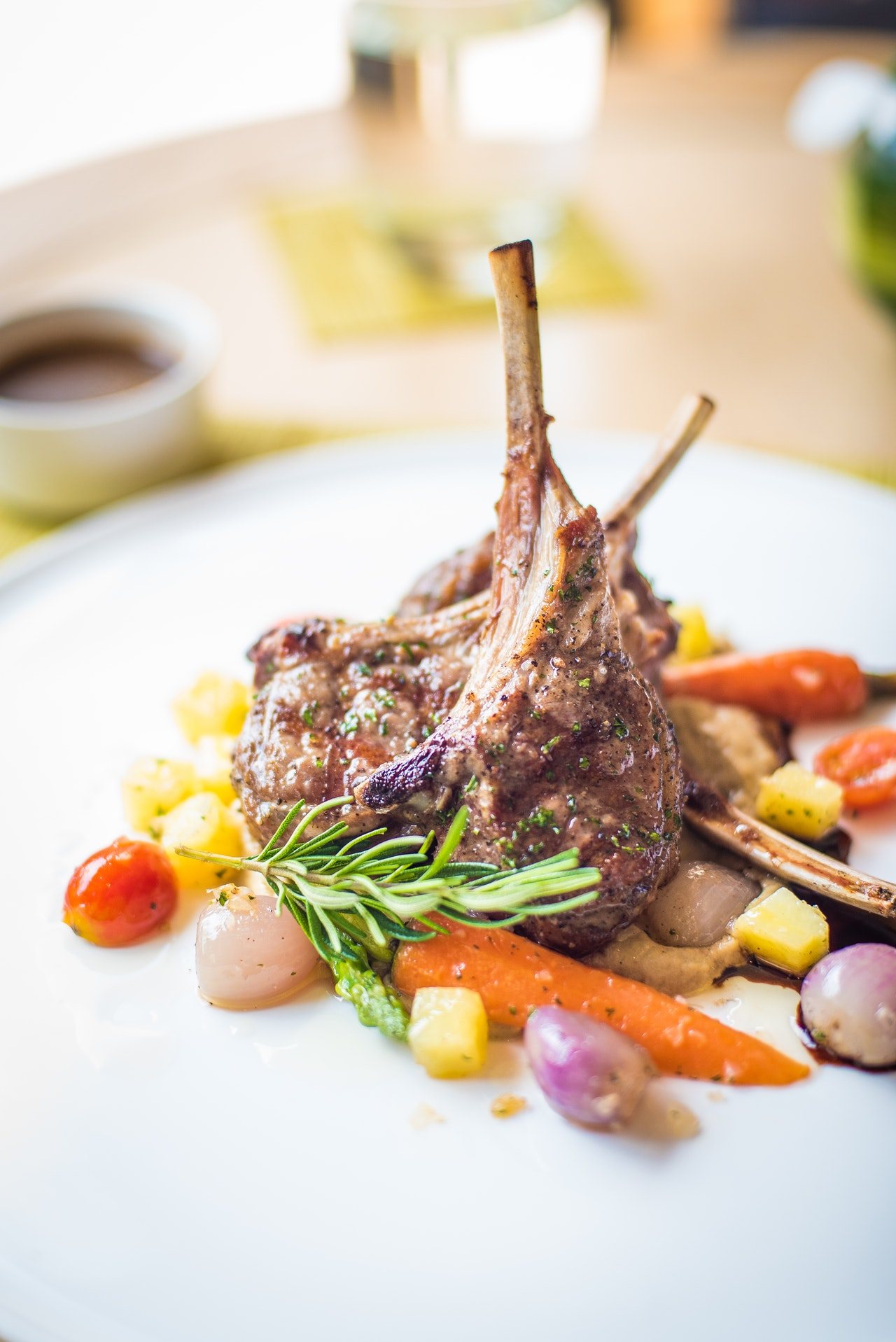 Plate with lamb chops and colorful vegetables