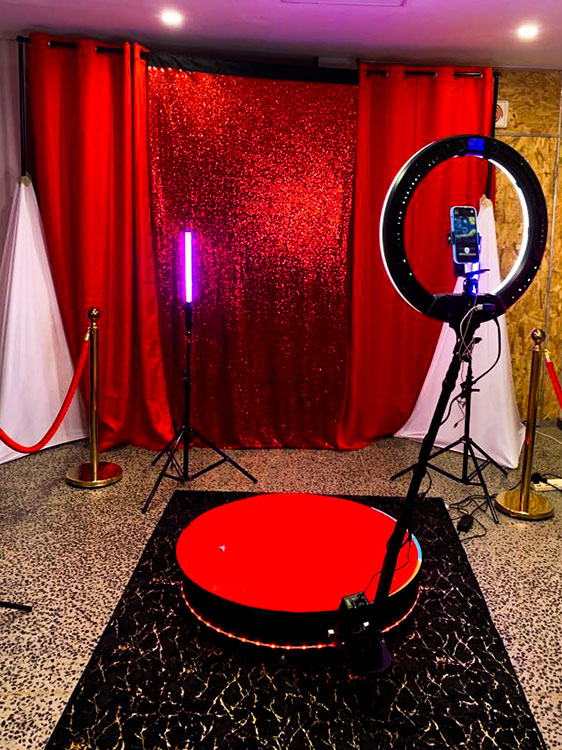 Mirror booth with red backdrop and lighting setup