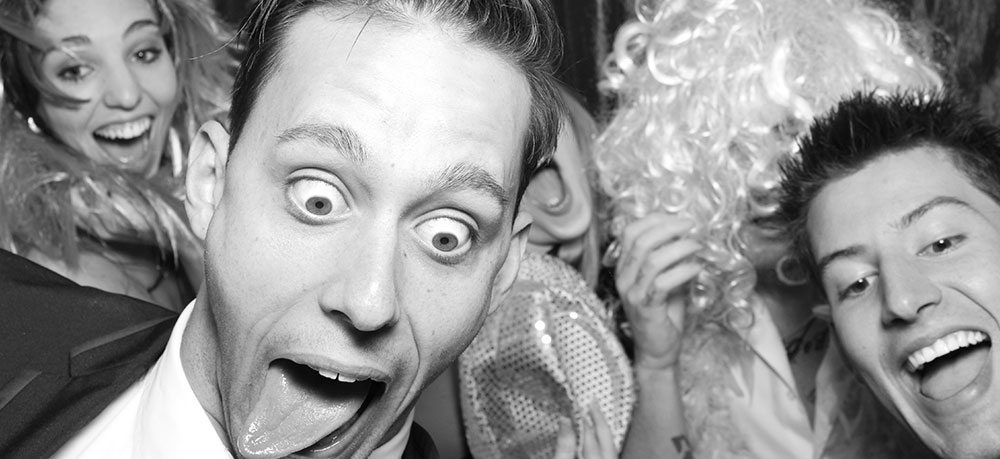 Group of guests enjoying a photo booth session with props.