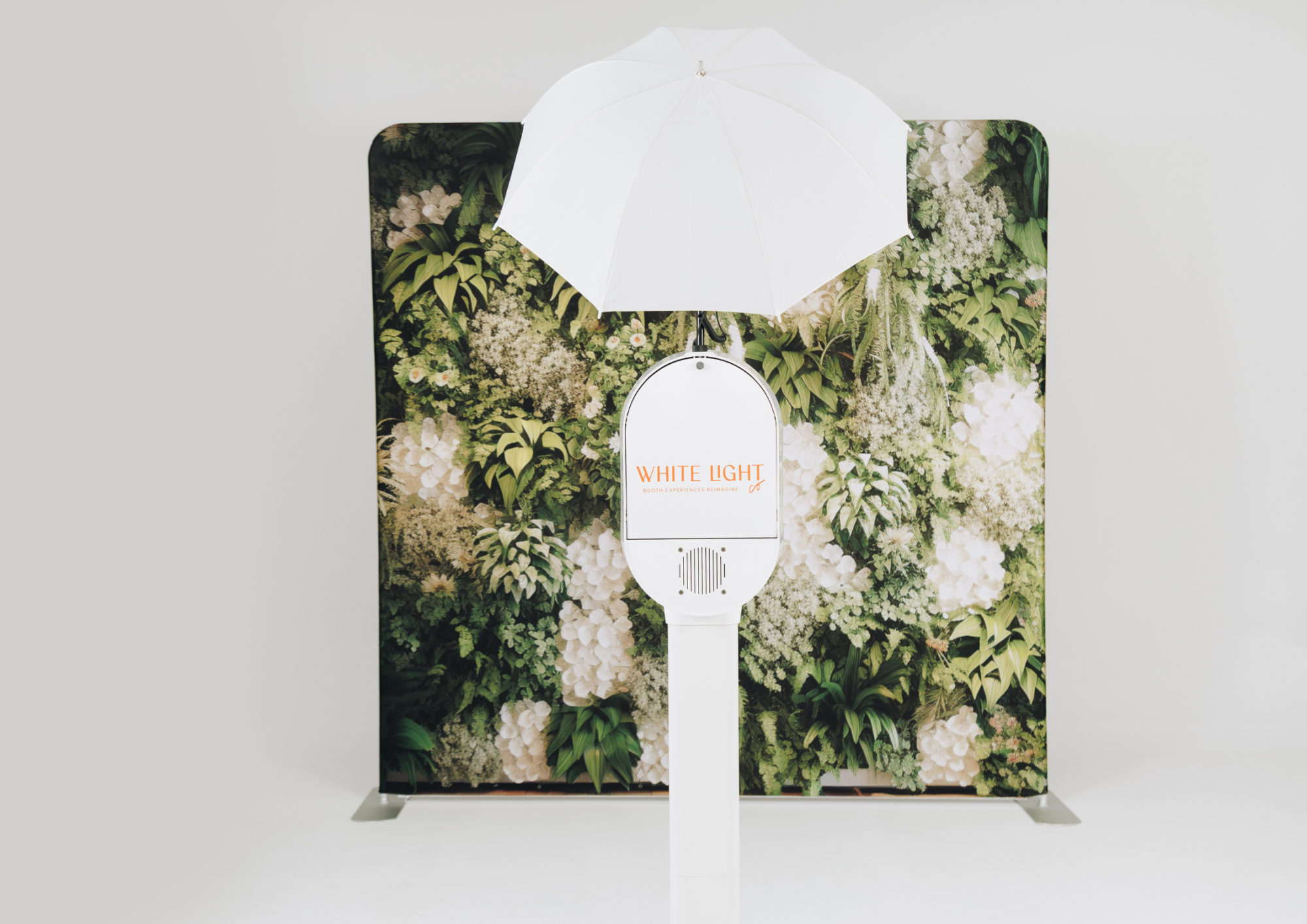 White photo booth with floral backdrop