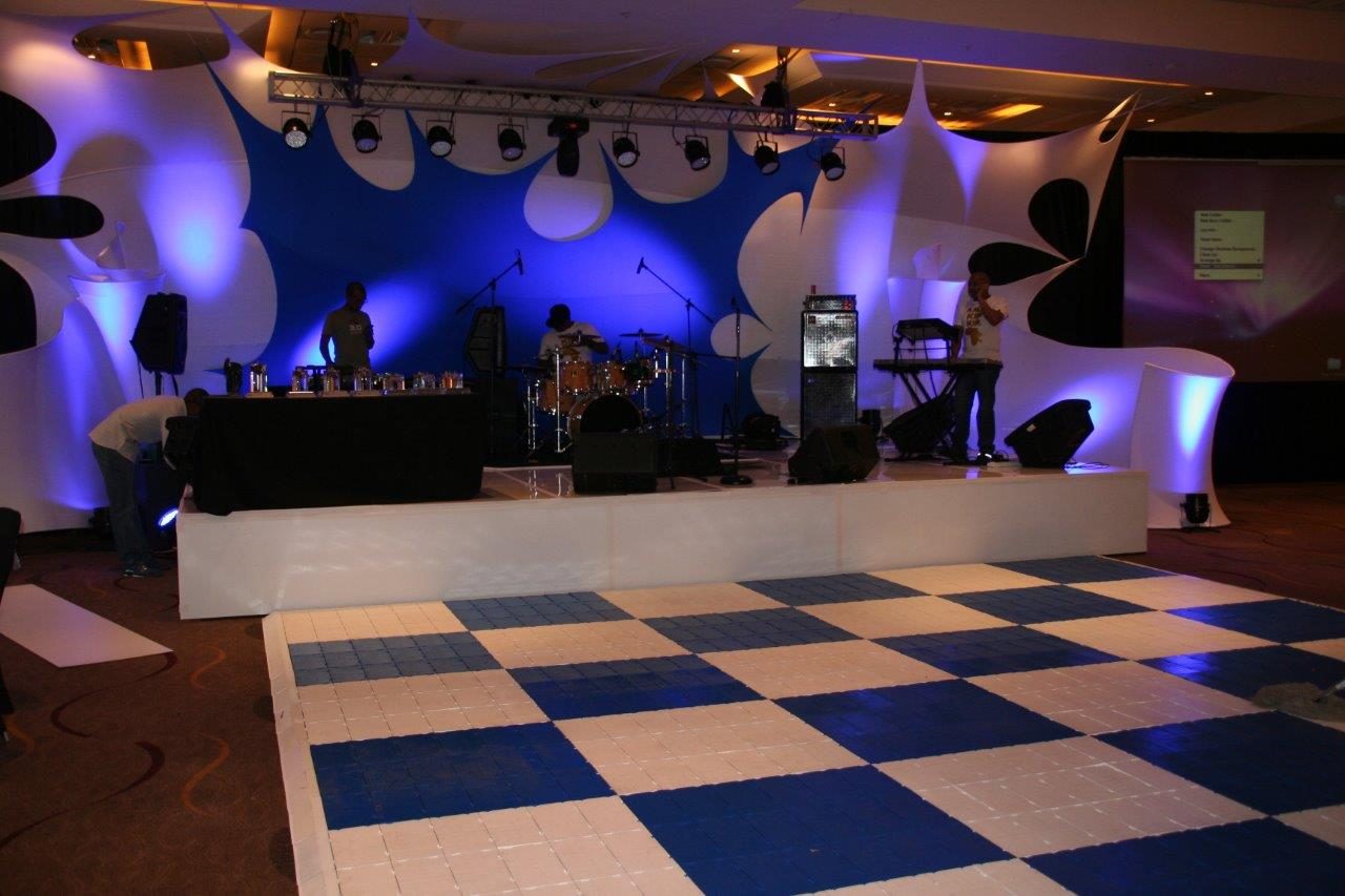 Black and white checkerboard dance floor with stage setup.