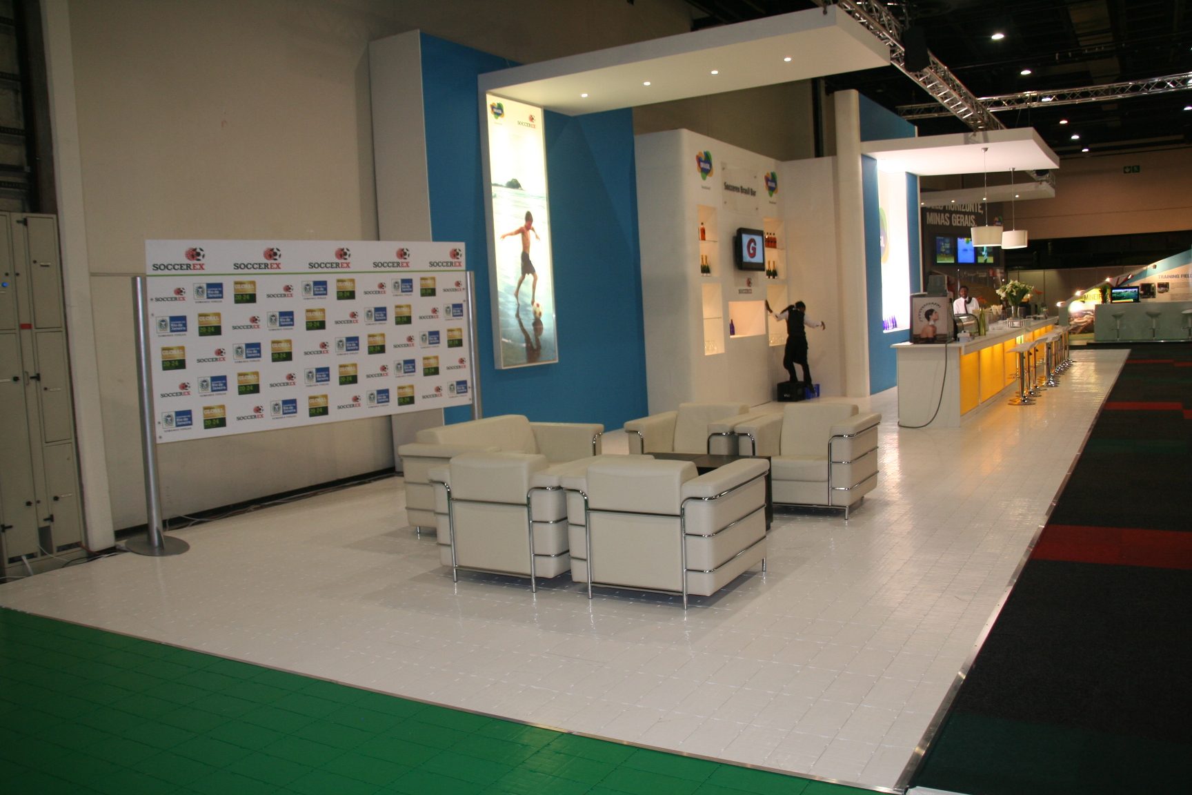 Modern exhibition area with white flooring and seating.