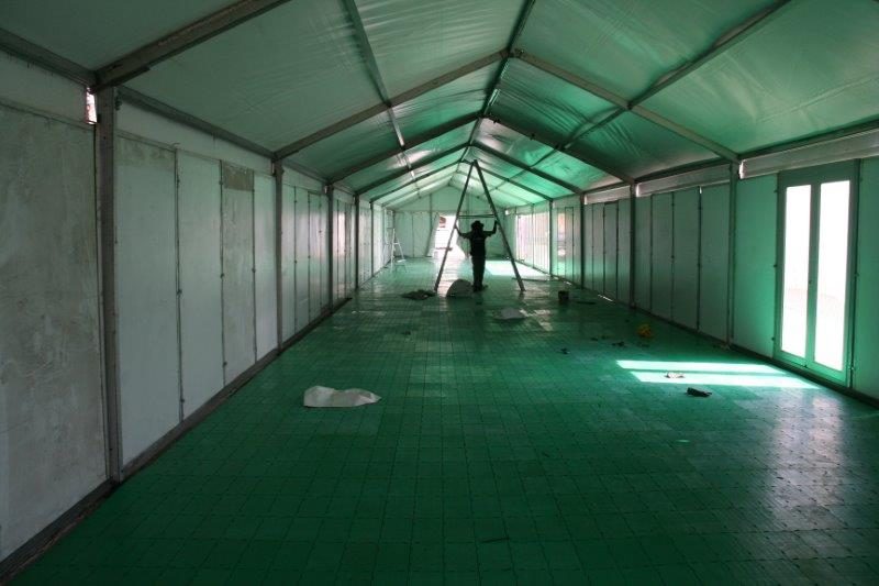 Interior of a tent with green portable flooring during installation