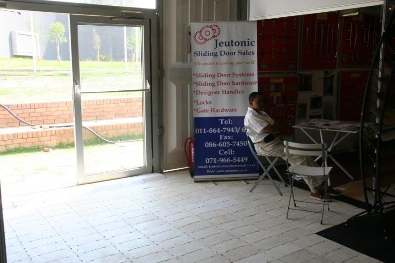 Interior view of a sliding door sales display with a seated person.
