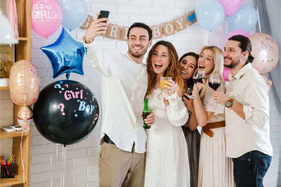 Group of friends celebrating with balloons and drinks