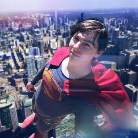 A superhero character overlooking a city skyline.