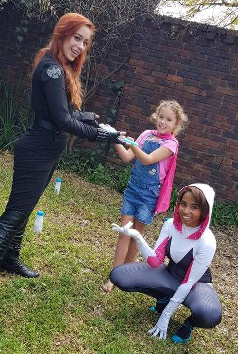 Two entertainers with kids in a garden setting