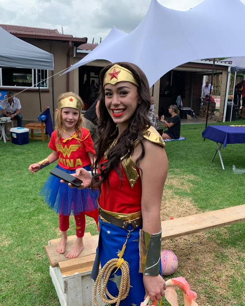 Costumed performer interacting with a child at a party