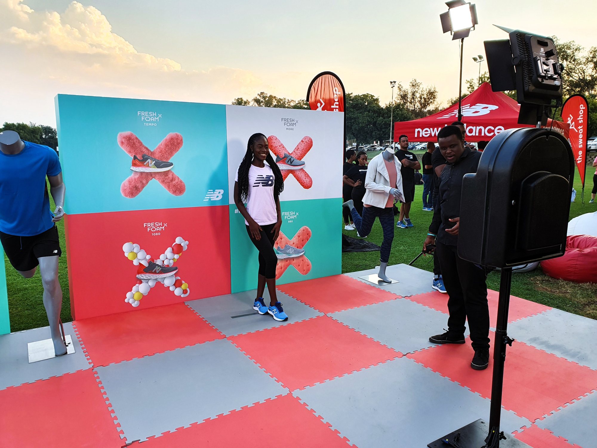 Photobooth setup with backdrop and camera equipment at an outdoor event