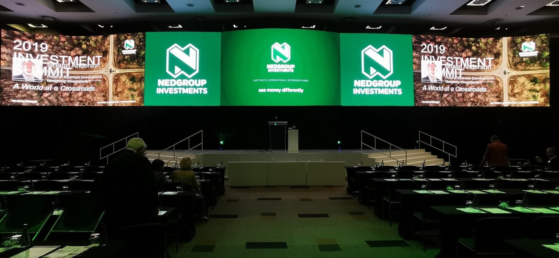 Conference stage with large screens and podium