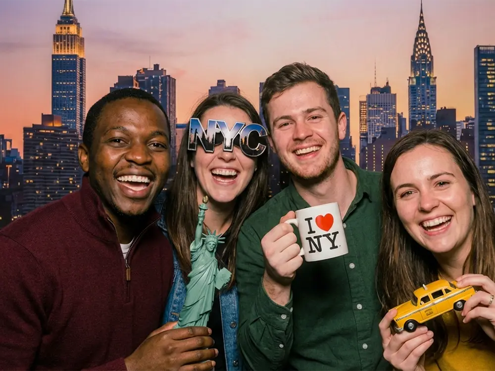Four friends with NYC props in photo booth