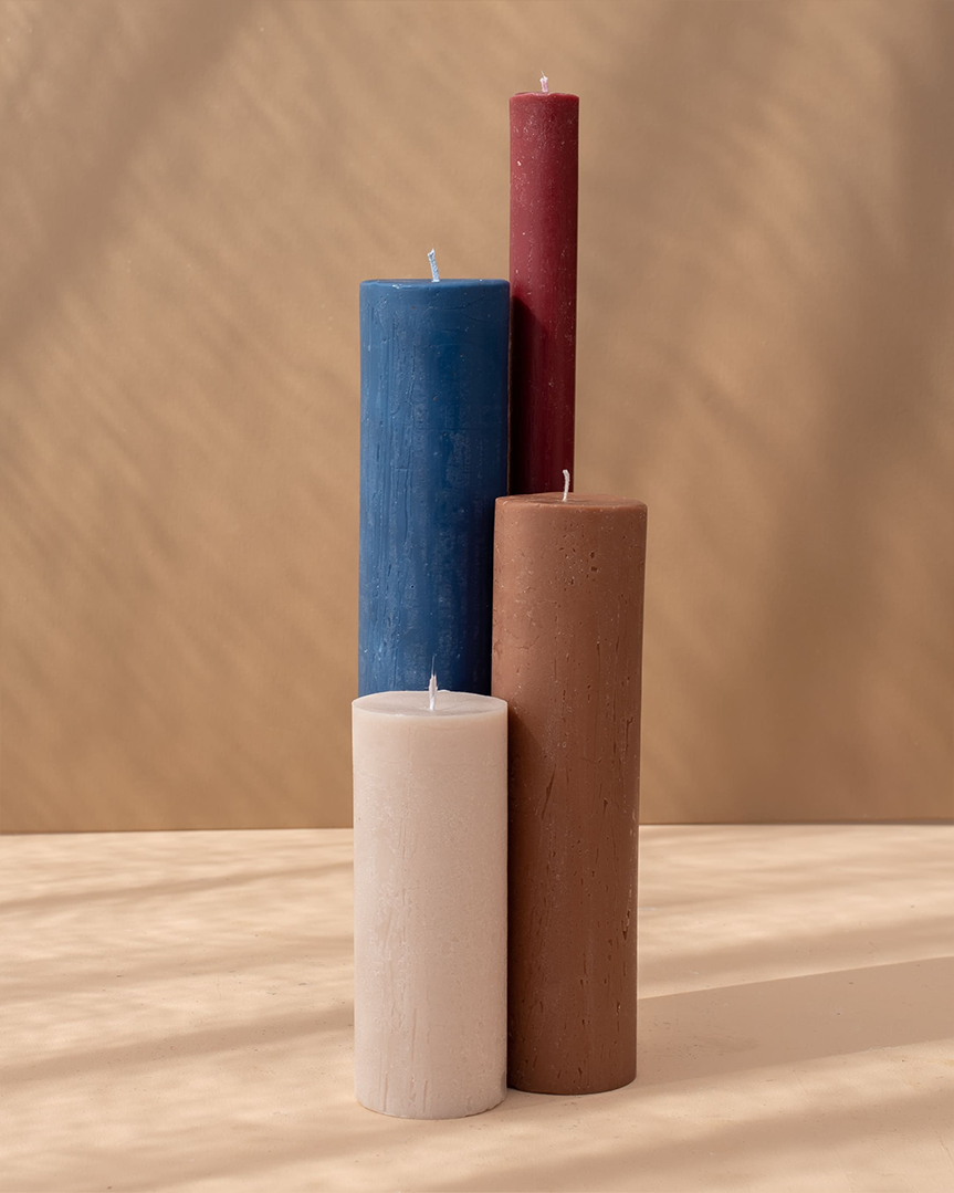 Four hand-poured candles in earthy and vibrant colors