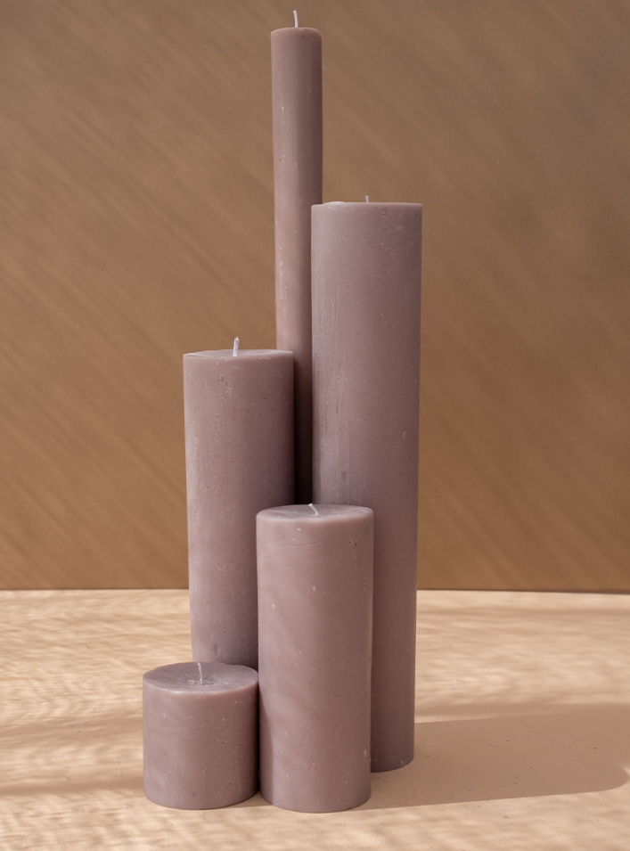 Collection of sculptural pillar candles in muted tones