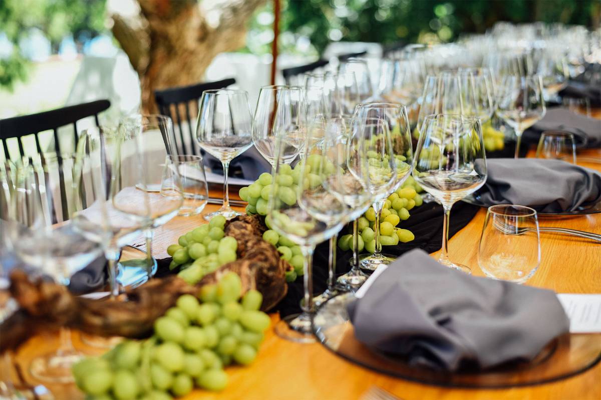 Table set with wine glasses and grapes at Rhebokskloof Estate