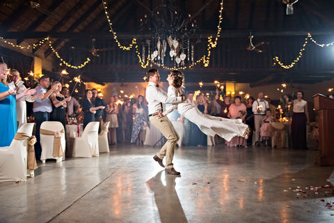 Couple dancing in a beautifully decorated venue with guests watching