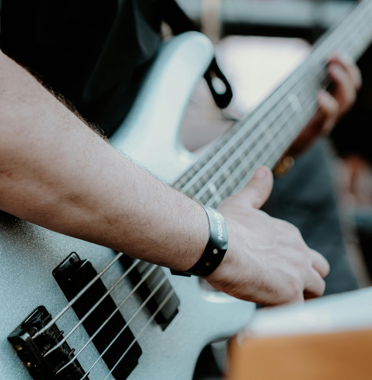 Close-up of a musician playing a bass guitar