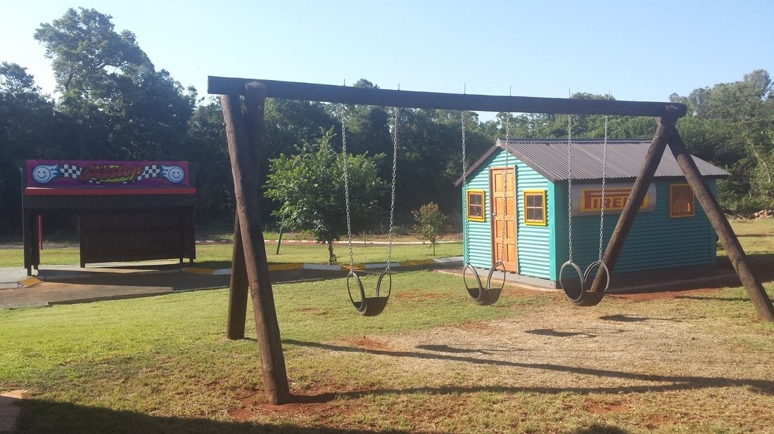 Children's swings and a colorful playhouse