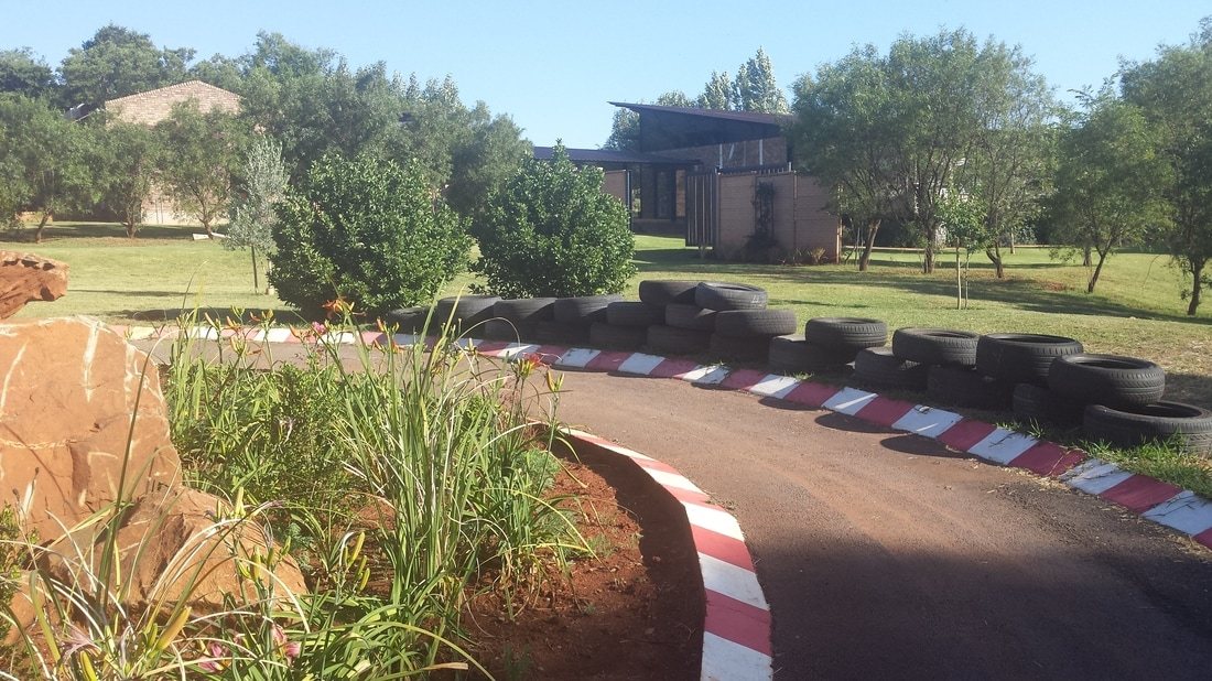 Mini racetrack with tires and garden landscaping
