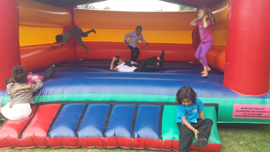 Children playing on a colorful bouncing castle