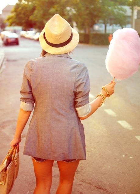 Person holding cotton candy in a casual outfit
