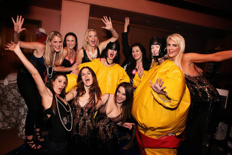 Group of women enjoying in colorful sumo suits