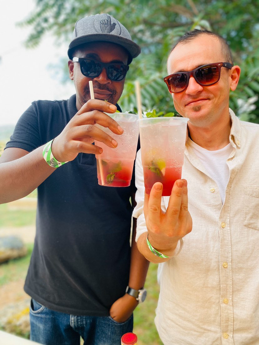 Two guests holding cocktails outdoors at an event