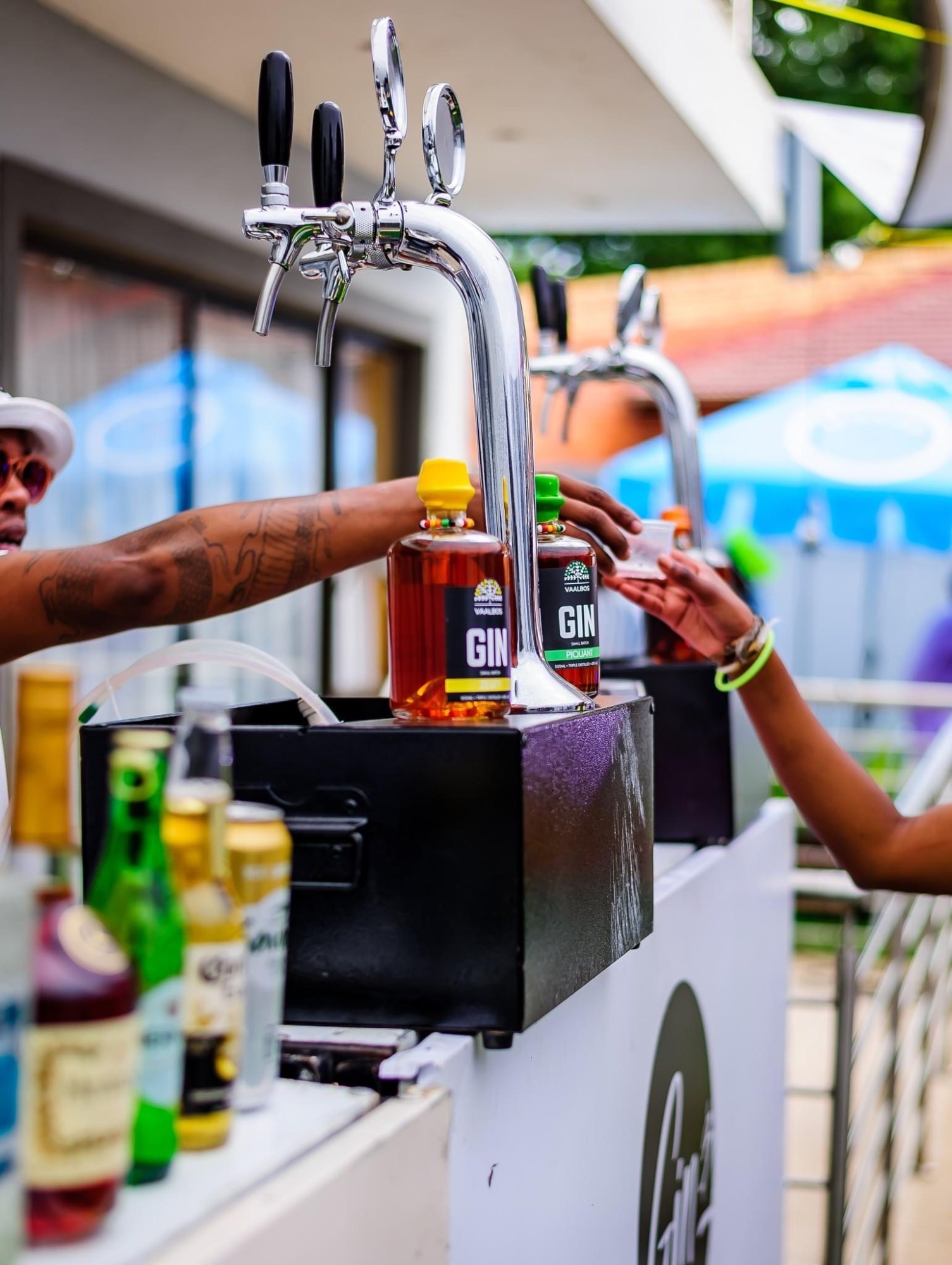 Mobile gin bar with drinks and staff serving guests