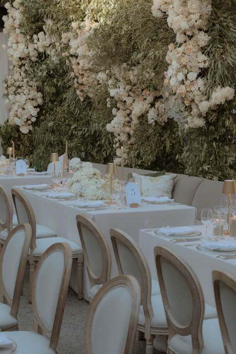 Elegant table decor with floral arrangements in the background