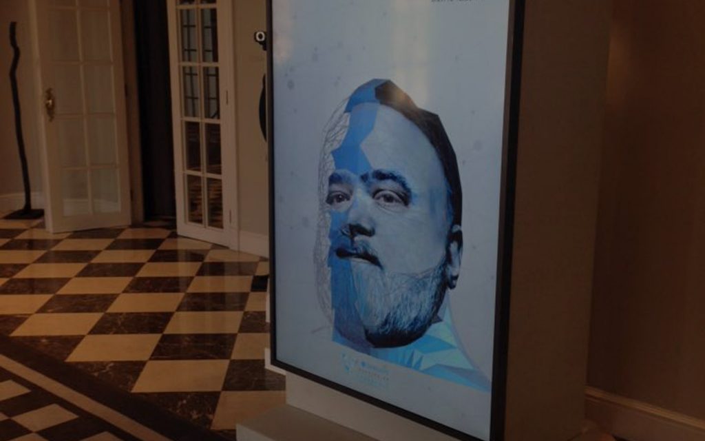 A digital display featuring an artistic portrait in blue tones.