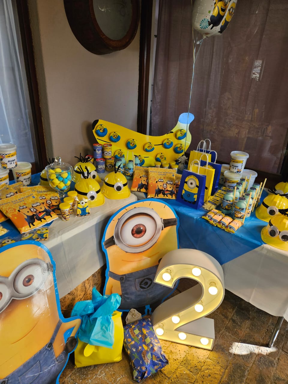 Minion-themed party setup with colorful decorations and favors