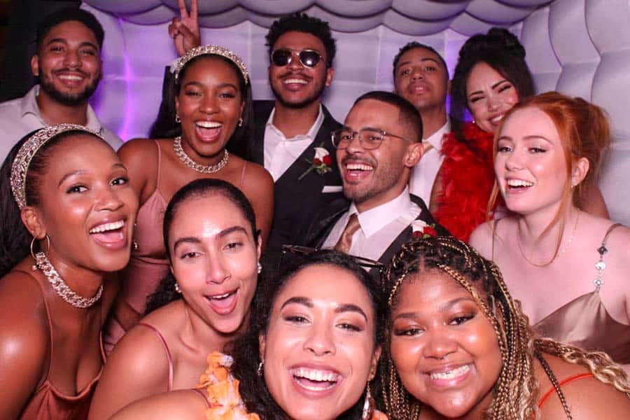 Group of friends posing in a photo booth