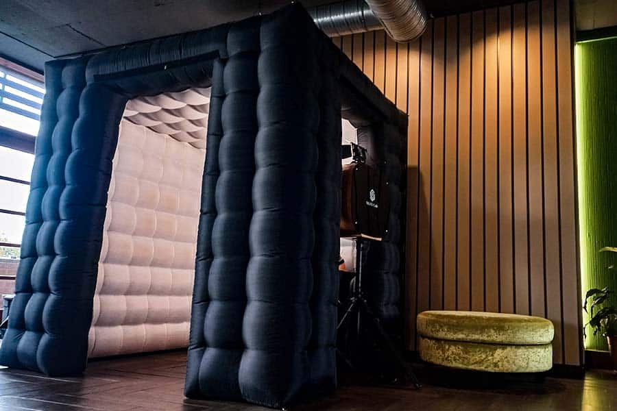 Inflatable photo booth with black exterior and beige interior