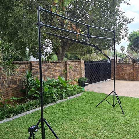 Black backdrop frame setup in grassy outdoor area.