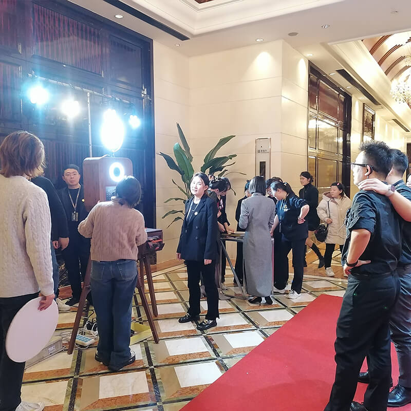 Guests using a 360° photo booth in a venue