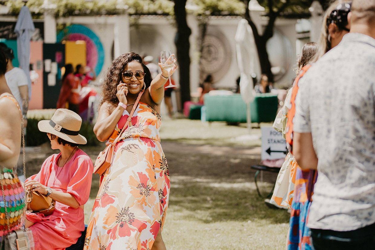 A joyful guest enjoying a drink at an outdoor party.