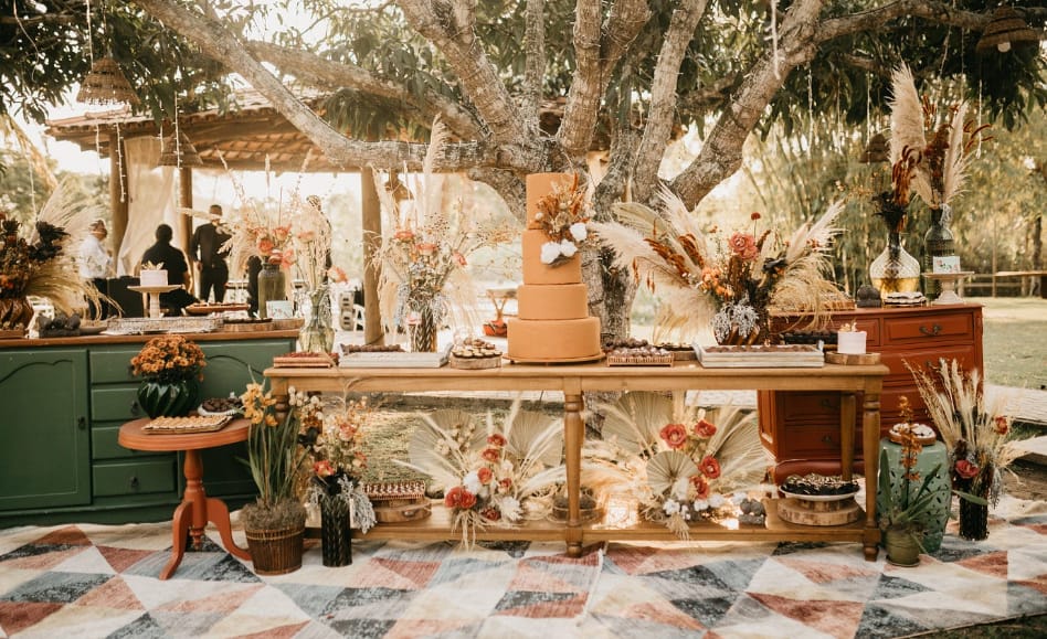 Decorative dessert table with flowers and a large cake