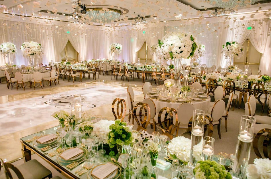 Luxurious wedding reception with floral centerpieces and elegant table settings.