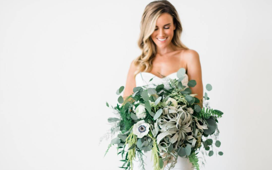 Bride with a large green and white bridal bouquet