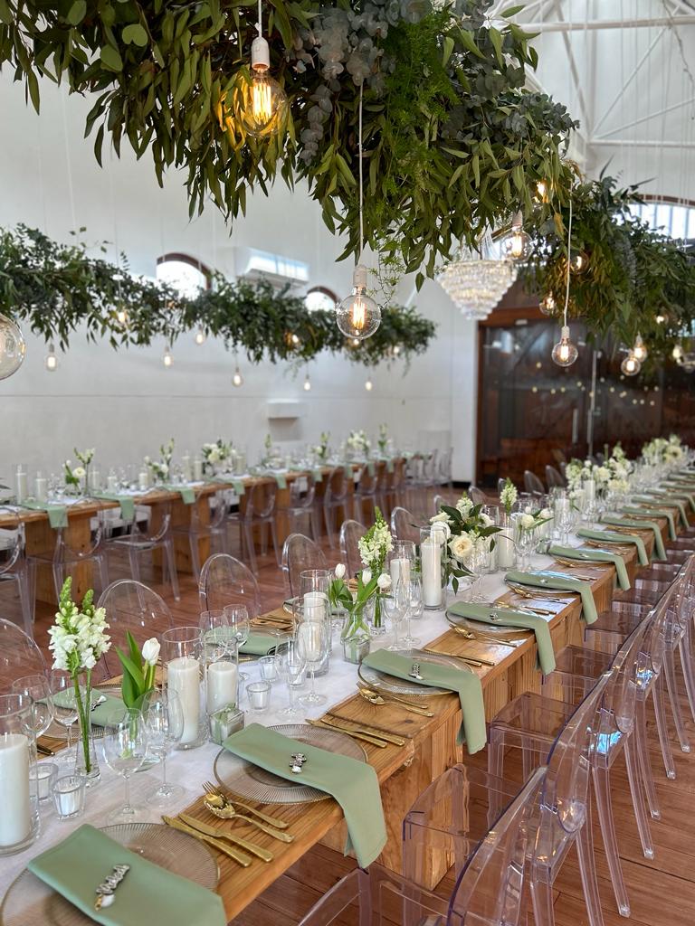 Long dining table with greenery and elegant table settings